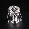 A direct front view of a solid sterling silver German skull ring, clearly showing its sparkling diamond eyes and detailed pilot helmet.