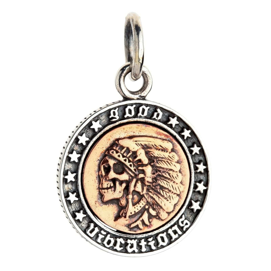 A front view of the copper and silver headdress skull pendant, isolated on a white background