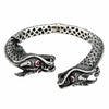 Double dragon head sterling silver cuff bracelet with ruby red eyes front view showing detailed scales
