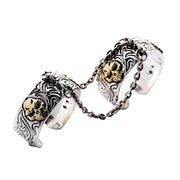 A front view of the adjustable double finger skull ring with gothic engravings.