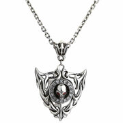 A sterling silver flaming skull shield pendant with red CZ eyes, shown hanging on a silver chain.