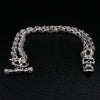 Flaming skull 925 sterling silver biker necklace with skull chain links and T-bar clasp on black leather background