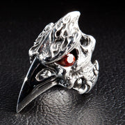 An angled view of the gothic bird skull ring, highlighting the red CZ stone eye and flame details.