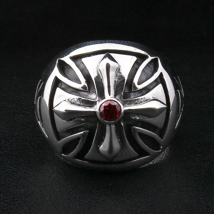 Gothic iron cross ring with deep red garnet stone top view showing polished silver finish