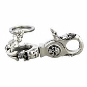 A close-up of the heavy-duty lobster clasp on the gothic skull biker keychain, showing intricate skull engravings.