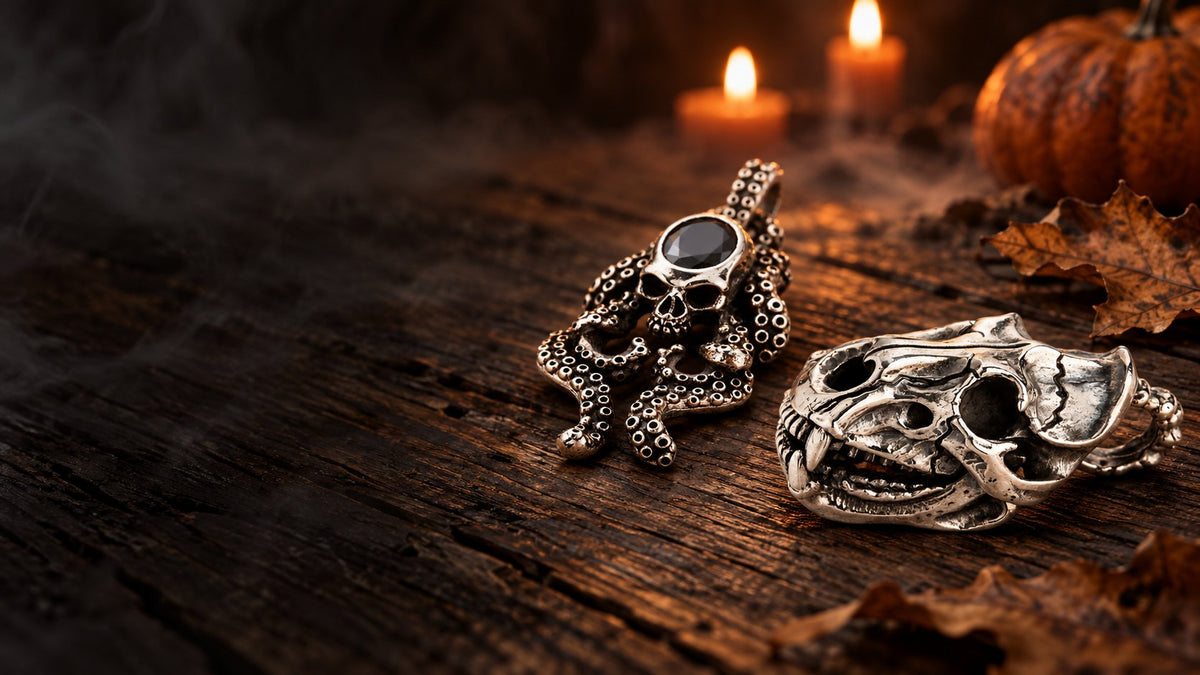 Tiger skull and octopus skull sterling silver pendants on dark wood by candlelight