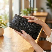 hands-holding-black-croc-