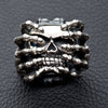 Front view of the heavy sterling silver spider skull ring, showing the skull gripped by skeleton hands.