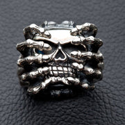 Front view of the heavy sterling silver spider skull ring, showing the skull gripped by skeleton hands.
