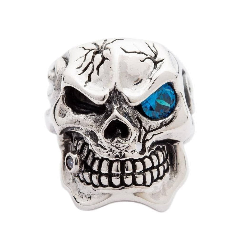 Anillo de calavera Mafia vista frontal con ojo de circonita cúbica topacio azul y diente de diamante en plata de ley