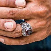 A man wearing the gothic cupid love ring, showcasing its bold statement size.