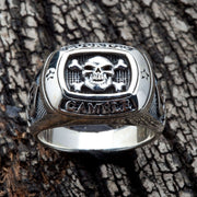 A men's solid sterling silver ring with a skull and crossbones and the word 'GAMBLE'.