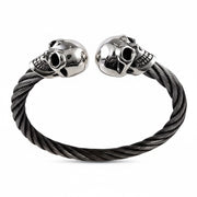 A front view of the men's skull cuff bracelet, showing the sterling silver skulls and the woven stainless steel band.