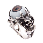 Front view of the men's gothic devil skull ring, showing the 925 sterling silver skull face holding a brown eyeball.