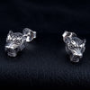 Pair of .925 silver tiger head studs facing forward on black leather, the 925 stamp visible on one butterfly back