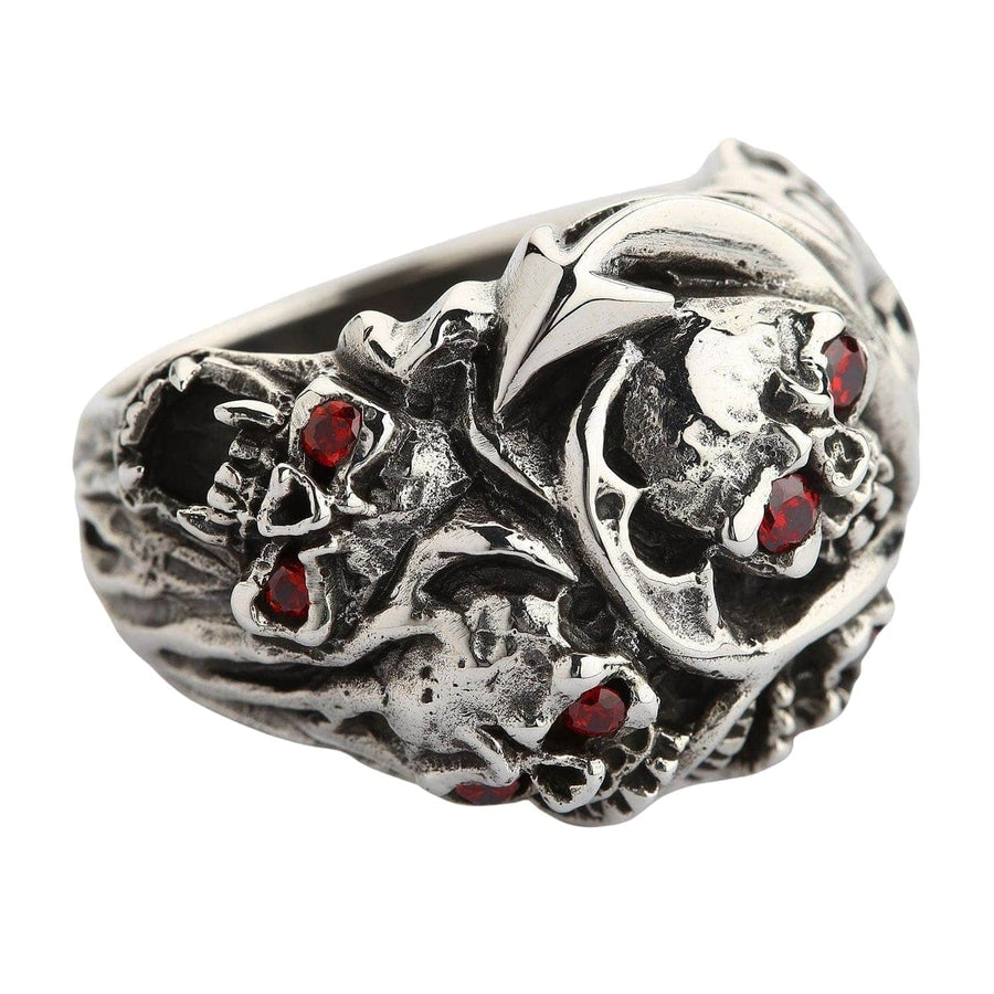 A solid sterling silver red eye devil ring with two genuine gemstone eyes and ornate, organic side carvings.
