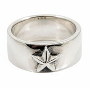 A front view of the sterling silver rock star band ring with a bold five-pointed star emblem, on a white background.