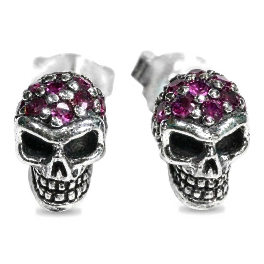 Ruby skull stud earrings in .925 sterling silver with red pavé stones, front view of both skulls
