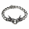 A men's solid sterling silver dragon bracelet with a 12mm Cuban link chain and double dragon head centerpiece with garnet eyes.