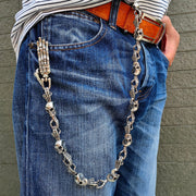 Man wearing heavy sterling silver skull wallet chain on blue jeans