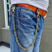 A man wearing a heavy solid brass Dorje wallet chain, showing its classic and stylish biker drape on a pair of blue jeans.