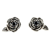 A pair of sterling silver black rose stud earrings with black CZ stones, on a white background.