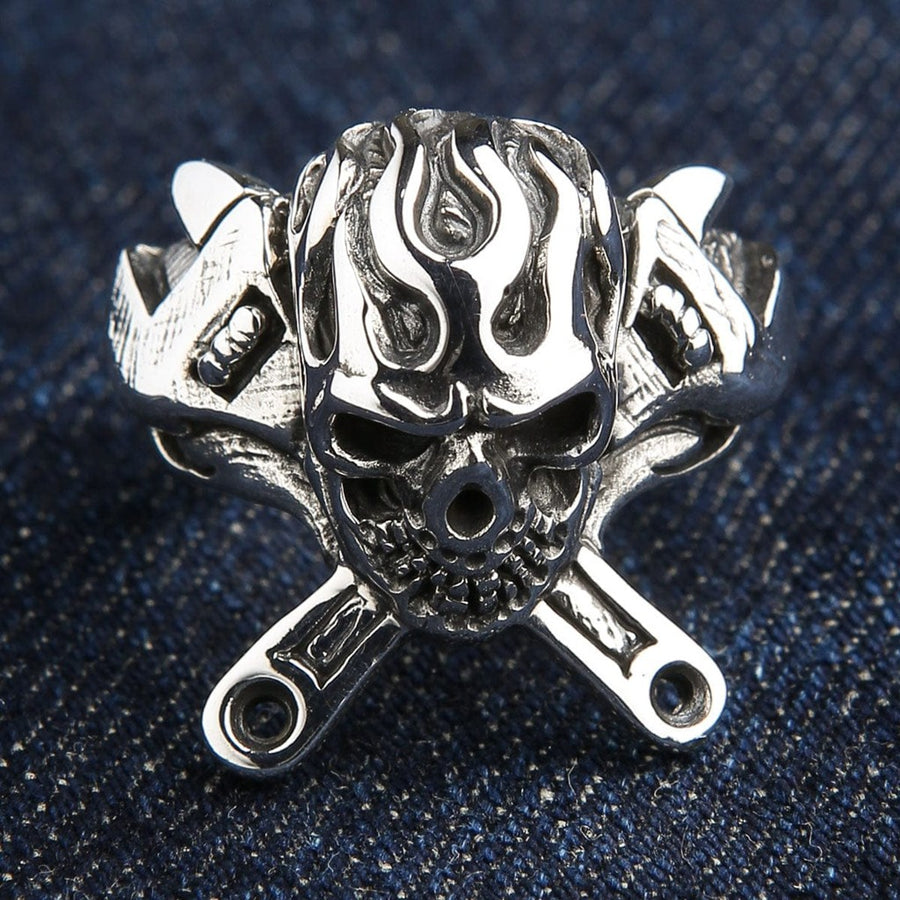 925 sterling silver flaming skull ring with crossed wrenches front view on denim background