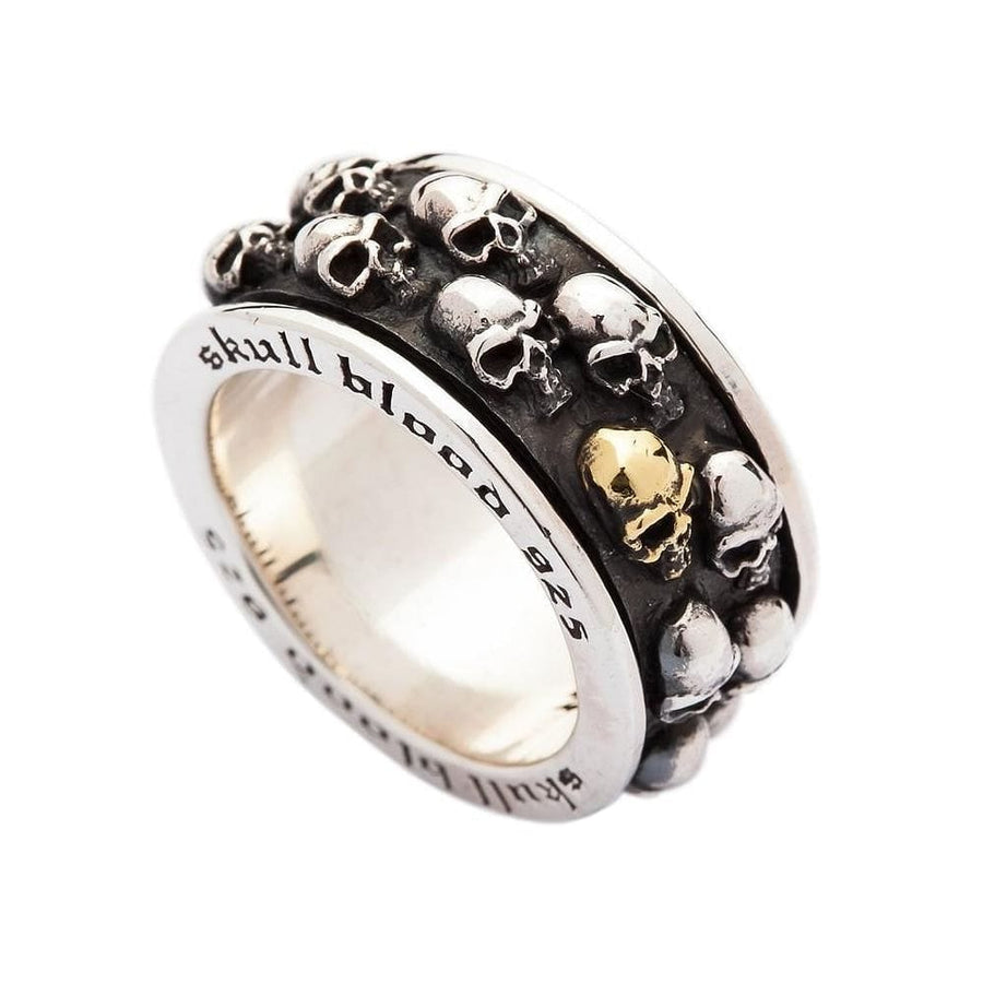 En ring i sterling sølv med skull spinner og en guld skull accent, der viser den gravede indre ring.