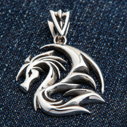 A front view of the sterling silver tribal dragon pendant, showing its openwork, stylized design.
