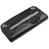 Black leather wallet with a flush-inlaid stingray skin cross, braided edges, and silver corner accents.