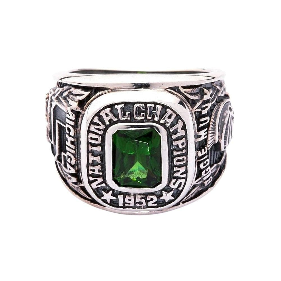 A front view of the 1952 Michigan State National Champions ring with a green stone.