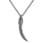 A solid sterling silver tusk pendant with an ornate cap featuring a beautifully detailed engraving of the Hindu god Ganesh.