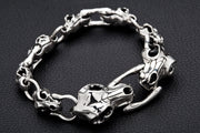 An angled view of the gothic ossuary link bracelet, highlighting the three-dimensional skulls.