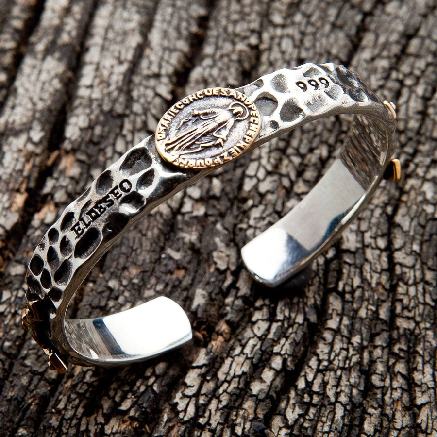 Hammered 925 sterling silver cuff with a gold-tone Virgin Mary Miraculous Medal medallion, shown at an angle