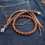 A front view of the light brown braided leather wallet chain with silver-tone clasps, resting on blue jeans.