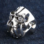 A side profile of the massive silver demon ring, showing its abstract openwork construction.