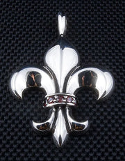 A front view of the large sterling silver Fleur de Lis pendant with a central band of red garnet stones